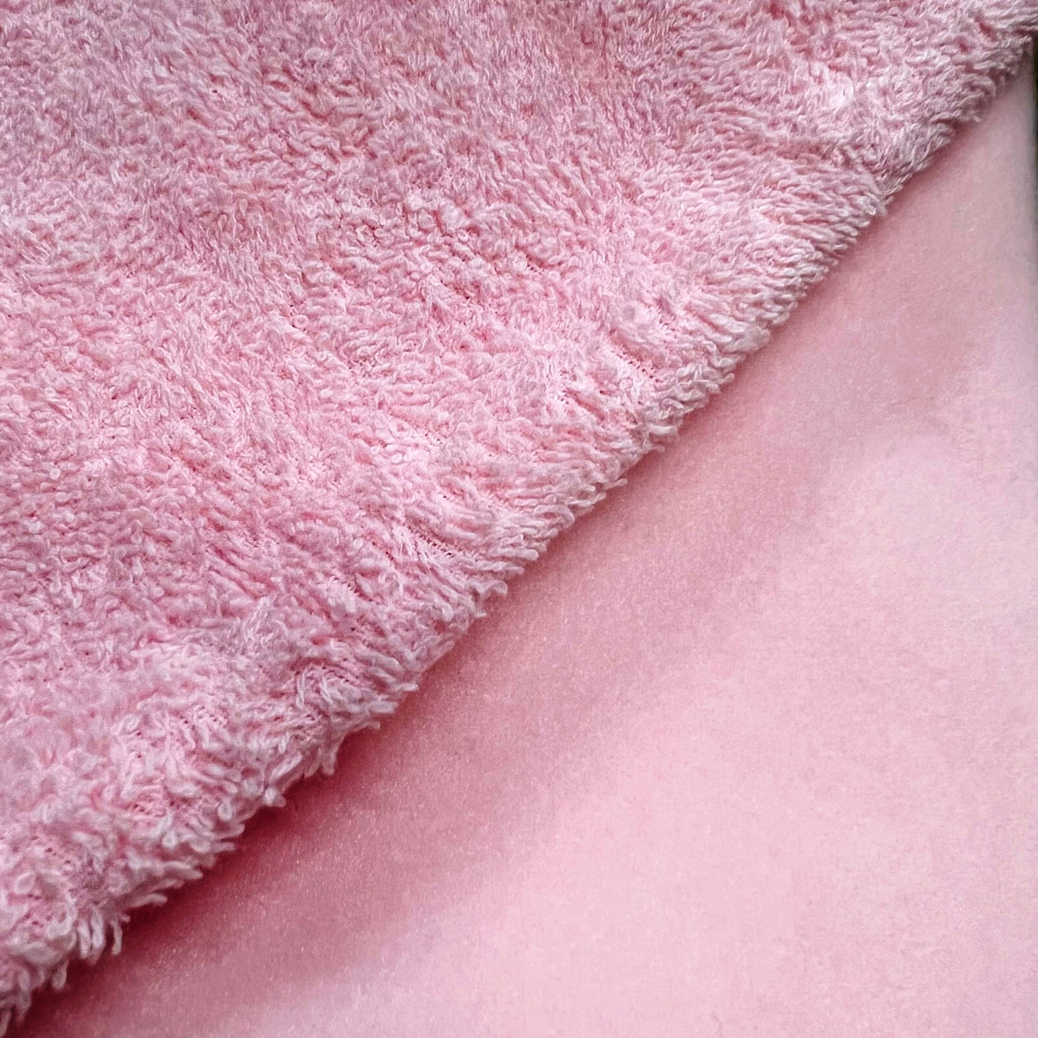 close up photo of burp cloth pink terry cloth and pink fleece